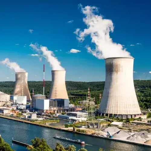 Power plant cooling towers beside a river